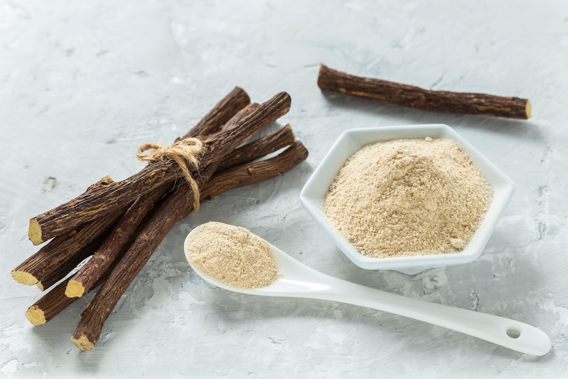 Powder and licorice root on the table - Glycyrrhiza glabra.